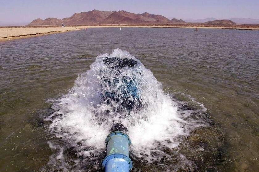 ** FILE **Well water bubbles into one of the pilot spreading basin pools for agricultural company Cadiz Inc., Aug. 13, 2002, in Cadiz, Calif. A controversial proposal to store surplus Colorado River water beneath the Mojave Desert, using similar pools, for use in Southern California was killed Tuesday, Oct. 8, 2002, by the Metropolitan Water District. The MWD board voted to not proceed with the $150 million project by Santa Monica-based Cadiz Inc. The project had been cited as a key part of California's plan to cut its overuse of Colorado River water by 2015. (AP Photo/Joe Cavaretta, File)