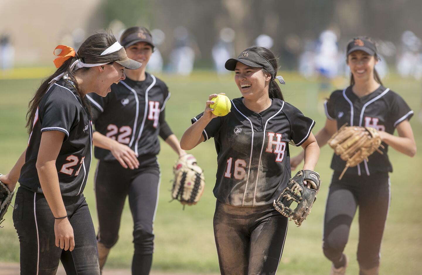 Huntington Beach's Megan Ryono (16) celebrates a great catch with Kelly Ryono, left, during a game in the Michelle Carew Classic against Vista Murrieta on Wednesday, April 4.
