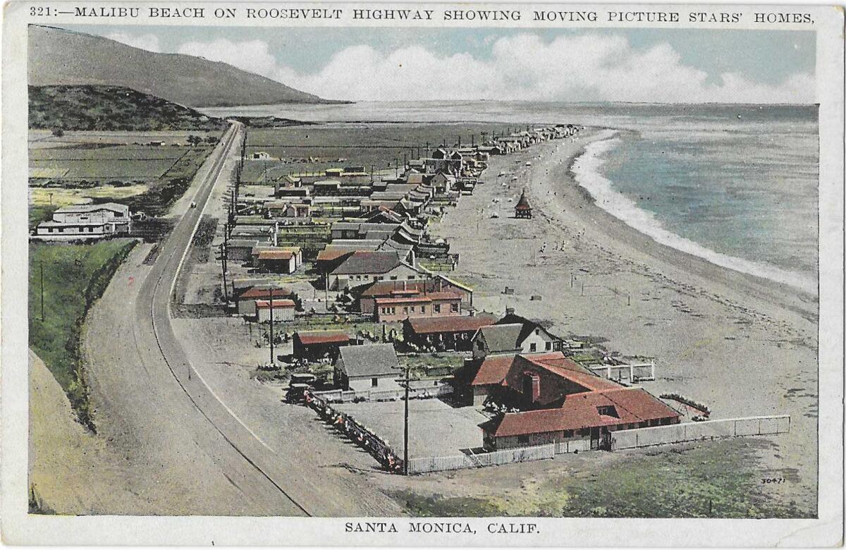 Large homes on the sand at a curve in the coastline 