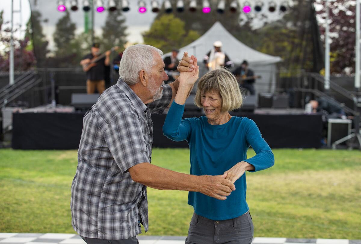 Peter Caide, left, and Cheryl Sletta dance to the music of the Zydeco Mudbugs during the Crawfish Festival.