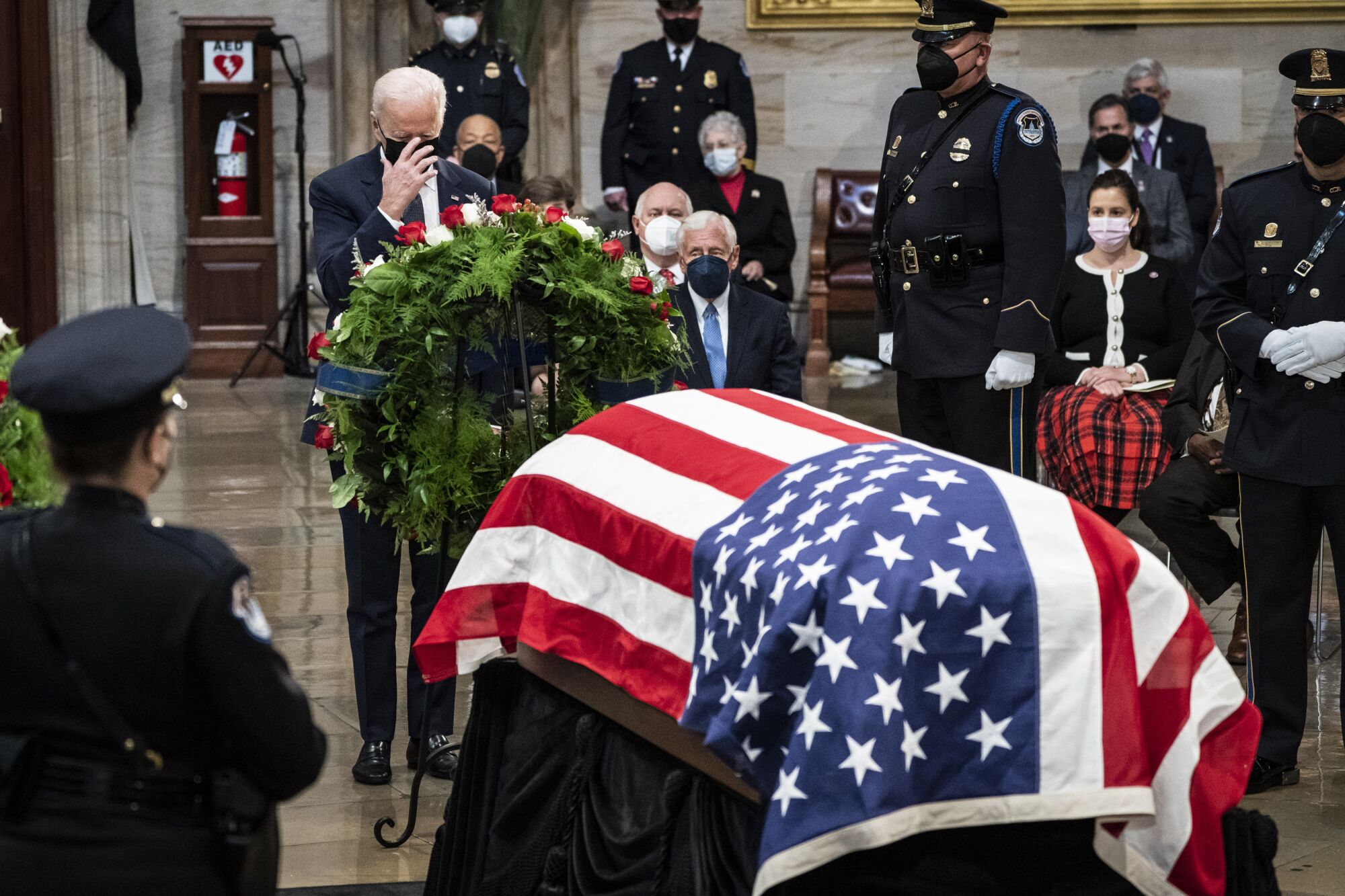 President Biden and the flag-draped casket of Sen. Bob Dole.