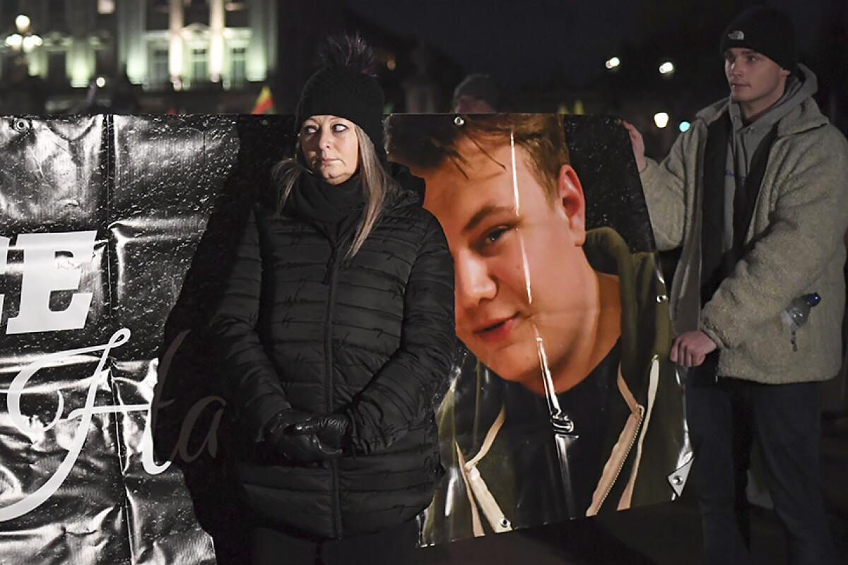 Charlotte Charles stands in front of a poster of her son, Harry Dunn, during a demonstration in London on Dec. 3, 2019