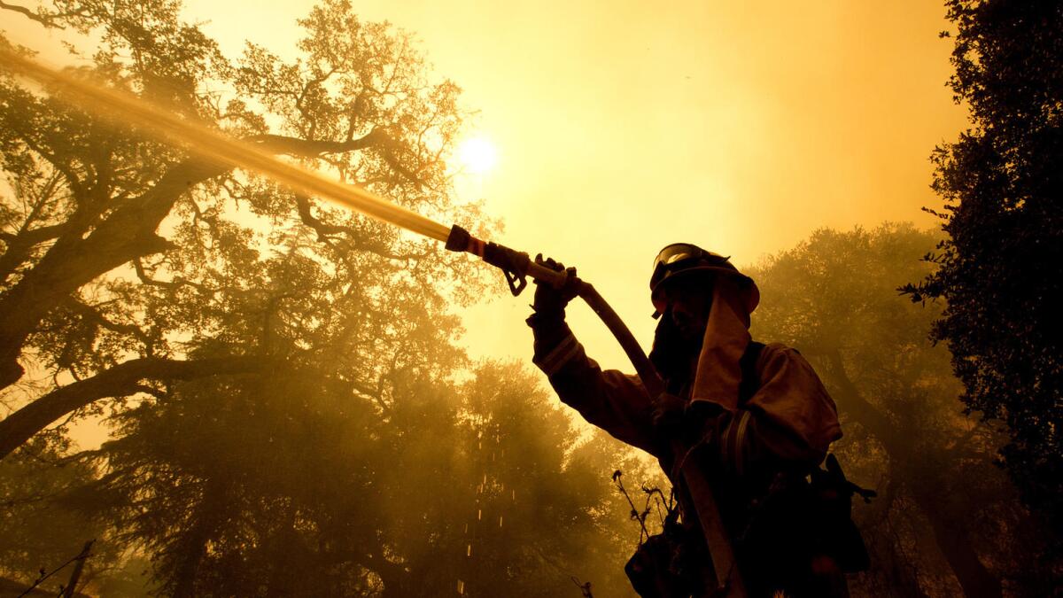 A Napa County firefighter battles flames.