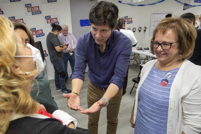 Los Angeles, CA - May 28: Mayoral candidate Kevin De Leon, center, talks with campaign volunteers along with California state senator Maria Elena Durazo, right, at his campaign headquarters on Saturday, May 28, 2022 in Los Angeles, CA. (Brian van der Brug / Los Angeles Times)