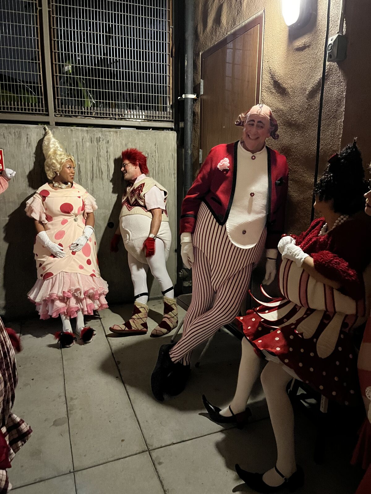 Actors lean on walls backstage at the Old Globe's "Dr. Seuss's How the Grinch Stole Christmas!" 