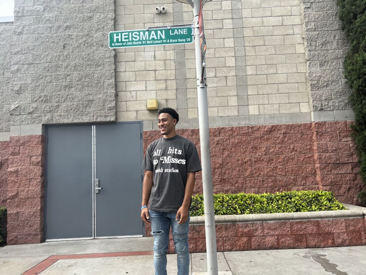 Heisman Trophy kazananı Bryce Young, Mater Dei'de güncellenen Heisman Lane tabelasının altında poz veriyor.