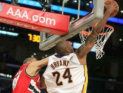 Lakers guard Kobe Bryant goes for a reverse dunk against Blazers forward Nicolas Batum during the first half. Bryant scored 17 of his game-high 26 points in the first half.