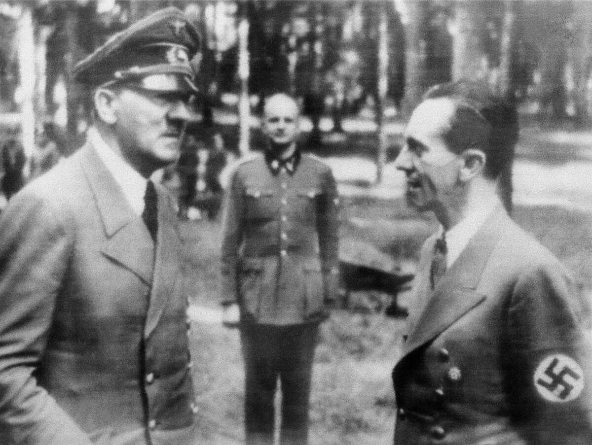 Two Nazi officials, Hitler and Goebbels