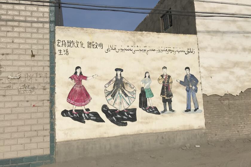 Murals on the walls of a village near Korla, Xinjiang, showed women bursting out of dark veils into colorful clothing. Another mural that minders obstructed the Times from photographing showed a large axe chopping Uighurs holding a flag associated with the region's independence into pieces.