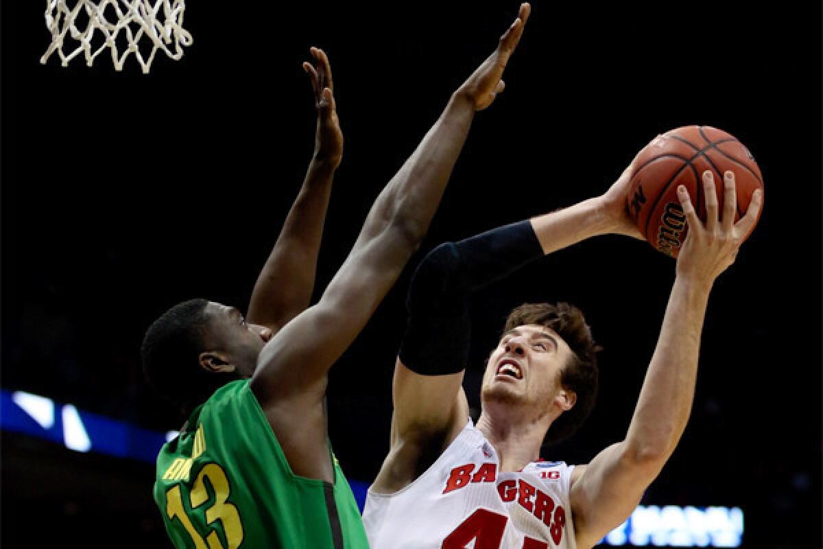 Wisconsin's Frank Kaminsky takes a shot over Oregon's Richard Amardi during the Badgers' 85-77 victory Saturday.
