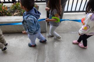 Long Beach, CA - March 20: Toddlers are strung together on their way to recess at Educare Los Angeles at Long Beach, a very high-quality child care center in Long Beach on Wednesday, March 20, 2024 in Long Beach, CA. (Brian van der Brug / Los Angeles Times)