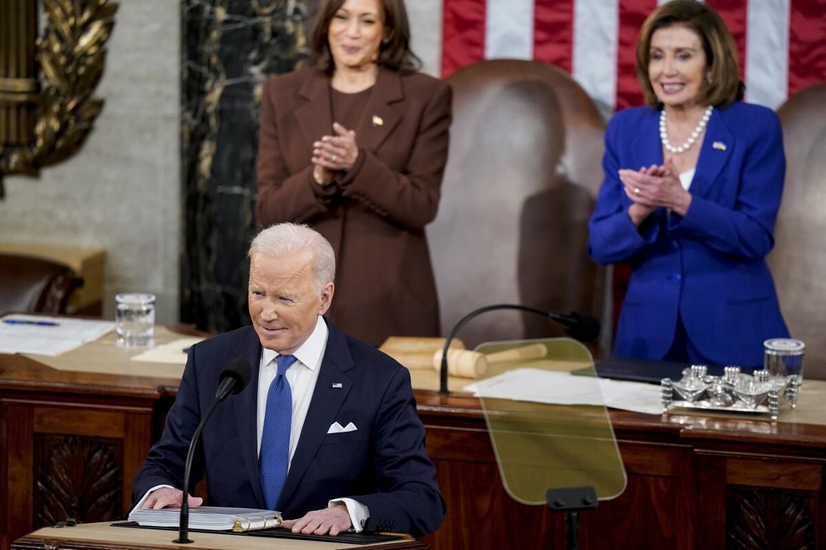 Vice President Kamala Harris and House Speaker Nancy Pelosi applaud President Biden.