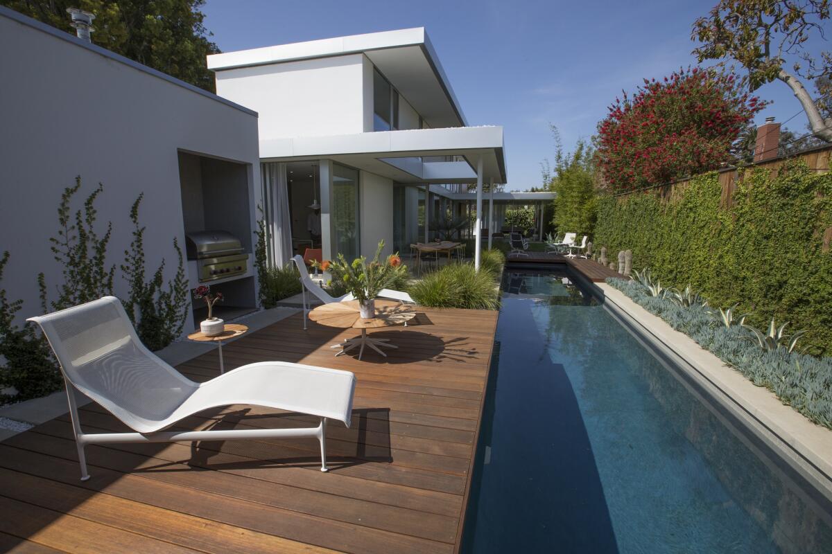 Outdoor furniture includes contour chaise lounges and a classic Petal coffee table by Richard Schultz from the 1960s. The landscape was designed by Chris Sosa. (Allen J. Schaben / Los Angeles Times)
