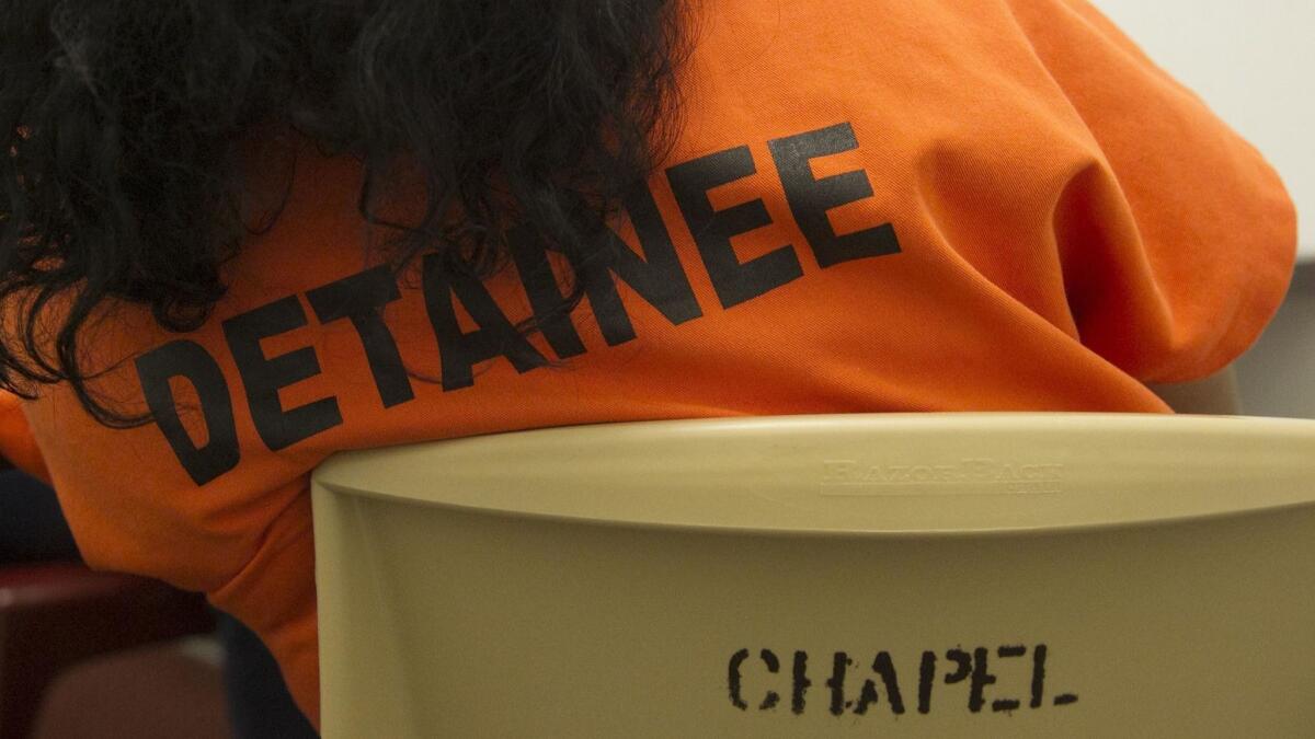 A Salvadoran woman sits in one of the legal visitation rooms at Otay Mesa Detention Center.