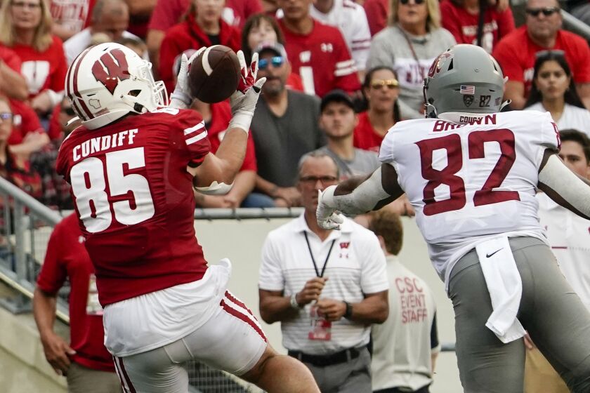 Wisconsin's Clay Cundiff catches a touchdown pass in front of Washington State's Travion Brown (82) during the first half of an NCAA college football game Saturday, Sept. 10, 2022, in Madison, Wis. (AP Photo/Morry Gash)