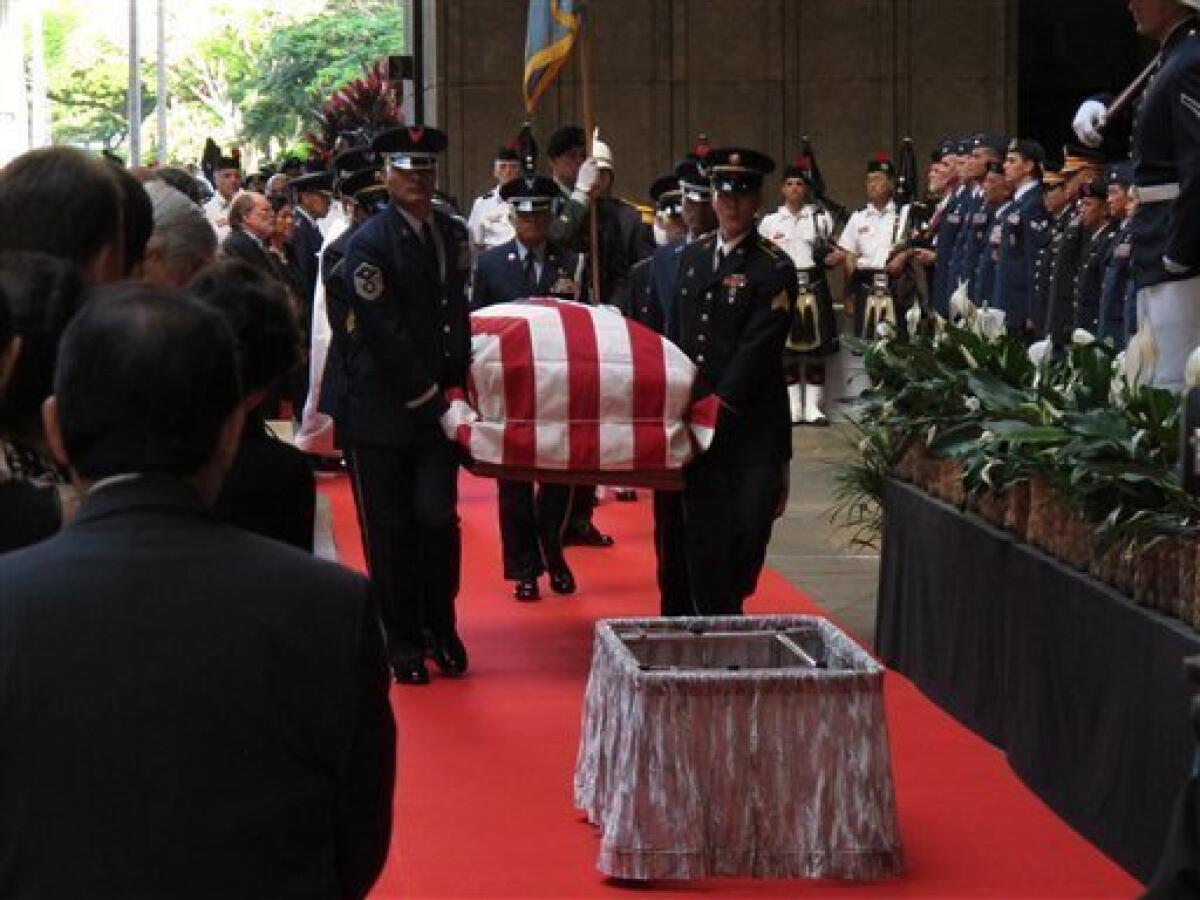 Pallbearers carry the casket of Sen. Daniel K. Inouye (D-Hawaii) into the courtyard of Hawaii's state Capitol during a ceremony in Honolulu the day before his funeral.