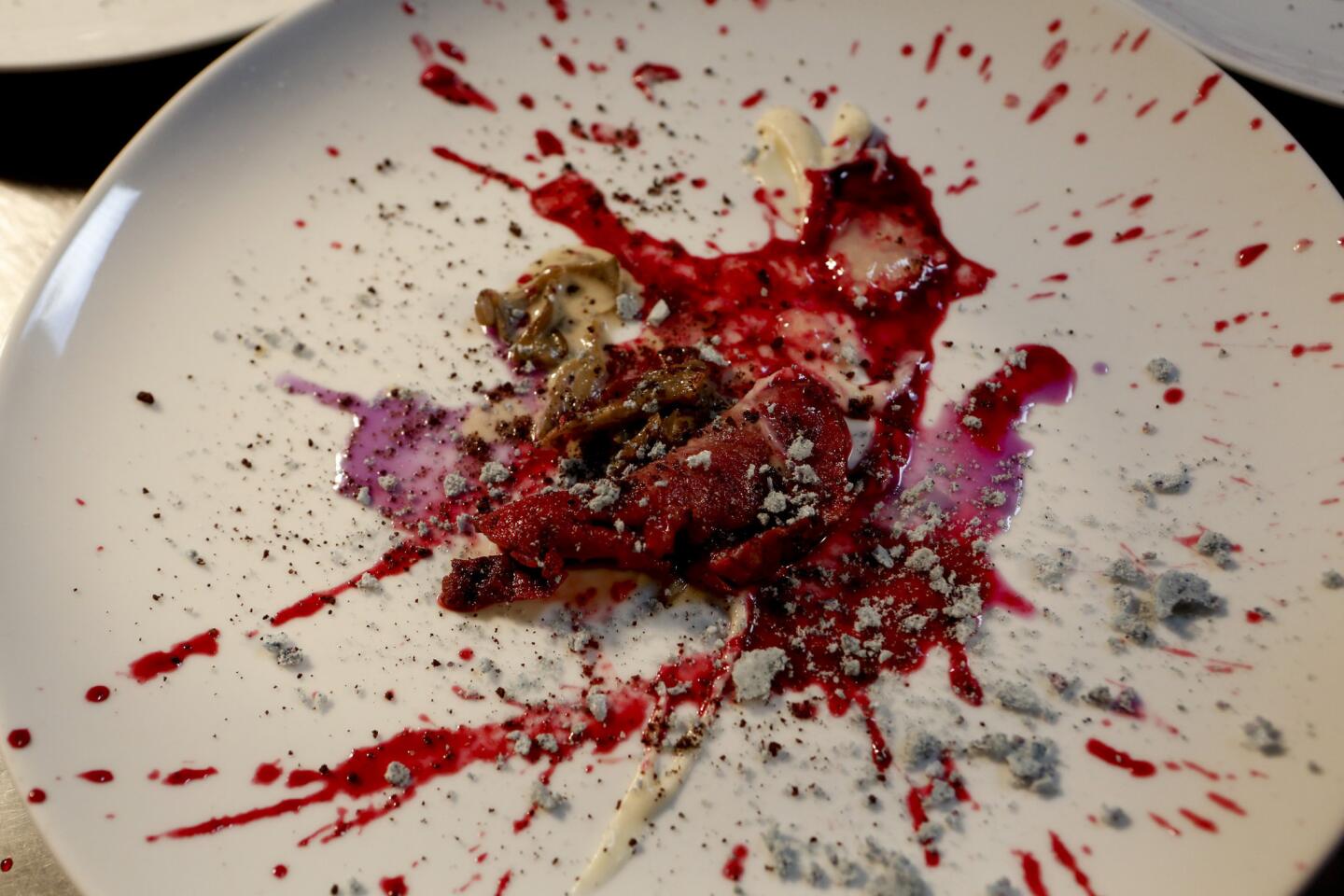 The Wolvesmouth signature dish, "Wolves in the Snow," with venison, pine gelee, blueberry meringue, cauliflower puree, hen of the woods mushrooms, cocoa coffee crumble, cabbage and blackberry.