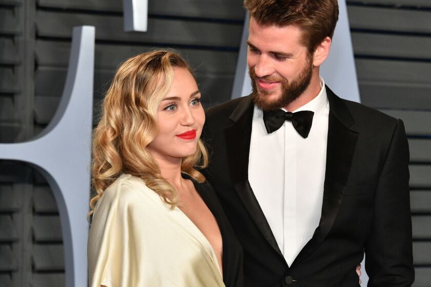 FILE: Singer/actor Miley Cyrus and actor Liam Hemsworth have married, according to posts on their social media accounts. BEVERLY HILLS, CA - MARCH 04: Miley Cyrus (L) and Liam Hemsworth attend the 2018 Vanity Fair Oscar Party hosted by Radhika Jones at Wallis Annenberg Center for the Performing Arts on March 4, 2018 in Beverly Hills, California. (Photo by Dia Dipasupil/Getty Images) ** OUTS - ELSENT, FPG, CM - OUTS * NM, PH, VA if sourced by CT, LA or MoD **