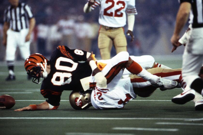 Cincinnati Bengals wide receiver Cris Collinsworth (80) fumbles the ball during Super Bowl XVI Jan. 24, 1982, at the Pontiac Silverdome in Pontiac, Mich. The San Francisco 49ers defeated the Cincinnati Bengals 26?2. (Tony Tomsic via AP)