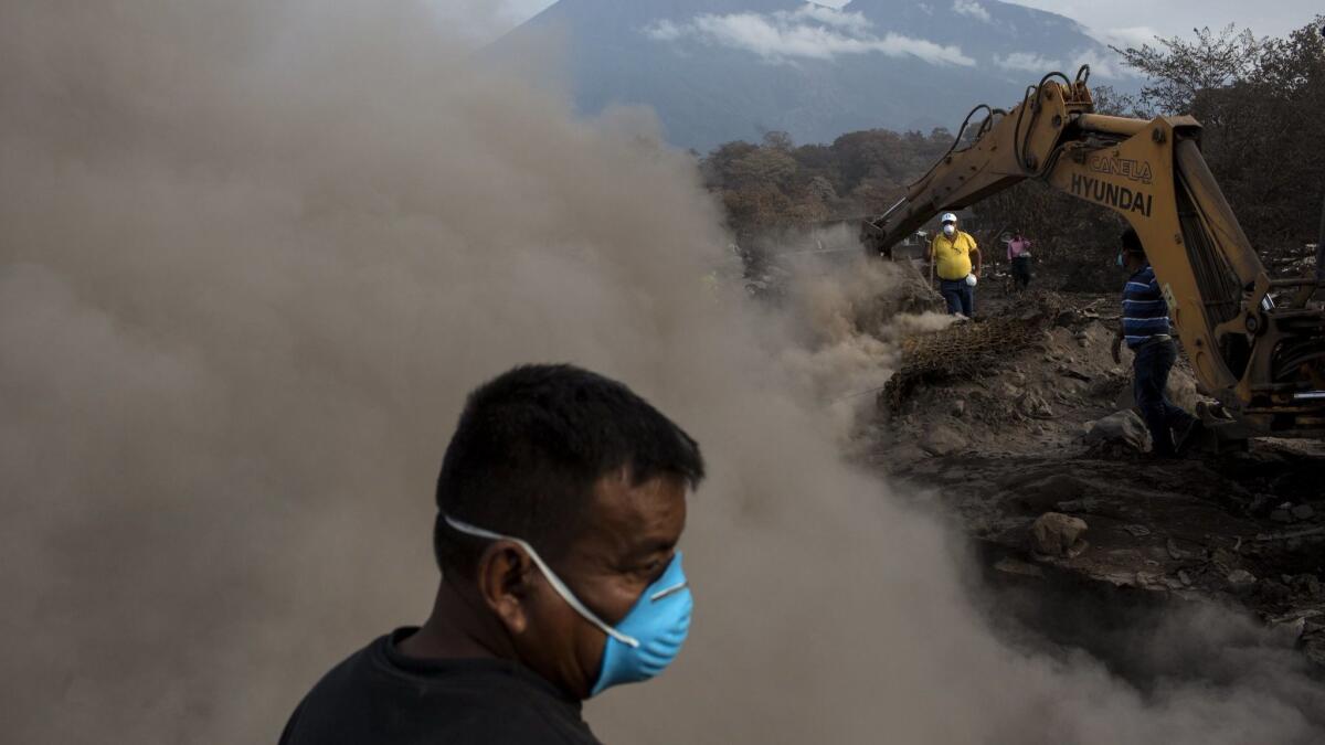 Mamerto Vazquez searches for family members presumably killed by the eruption of the Volcano of Fire at his home buried in volcanic ash in San Miguel Los Lotes, Guatemala, on June 14.