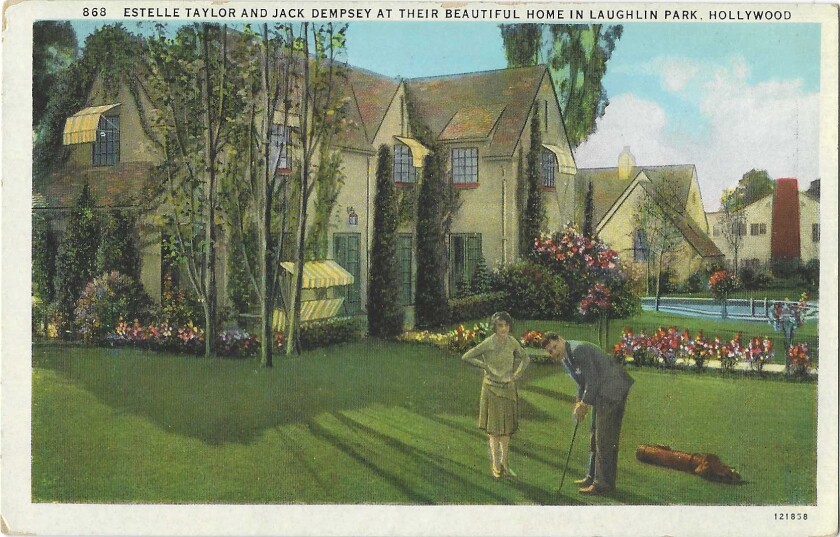 A vintage postcard of a couple on their lawn.