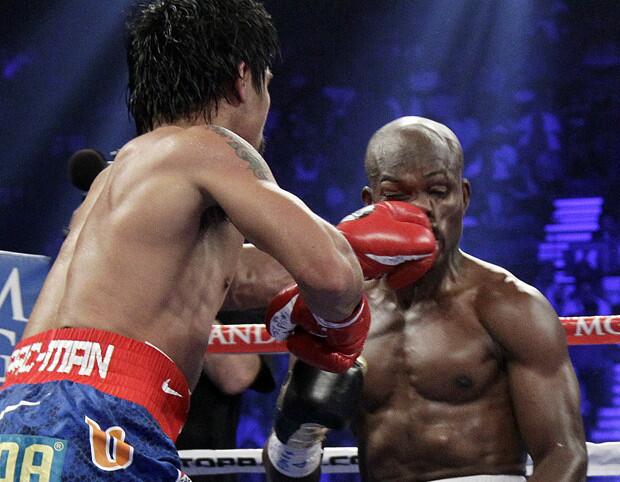 Manny Pacquiao lands a punch to the face of Timothy Bradley.