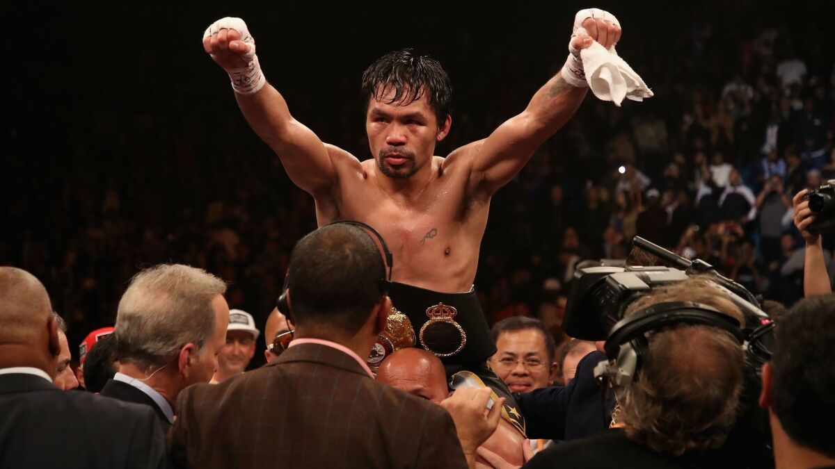 Manny Pacquiao celebrates after defeating Adrien Broner by unanimous decision during the WBA welterweight championship at MGM Grand Garden Arena on Saturday in Las Vegas.