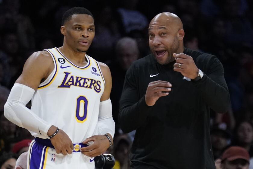 Los Angeles Lakers head coach Darvin Ham, right, talks to guard Russell Westbrook.