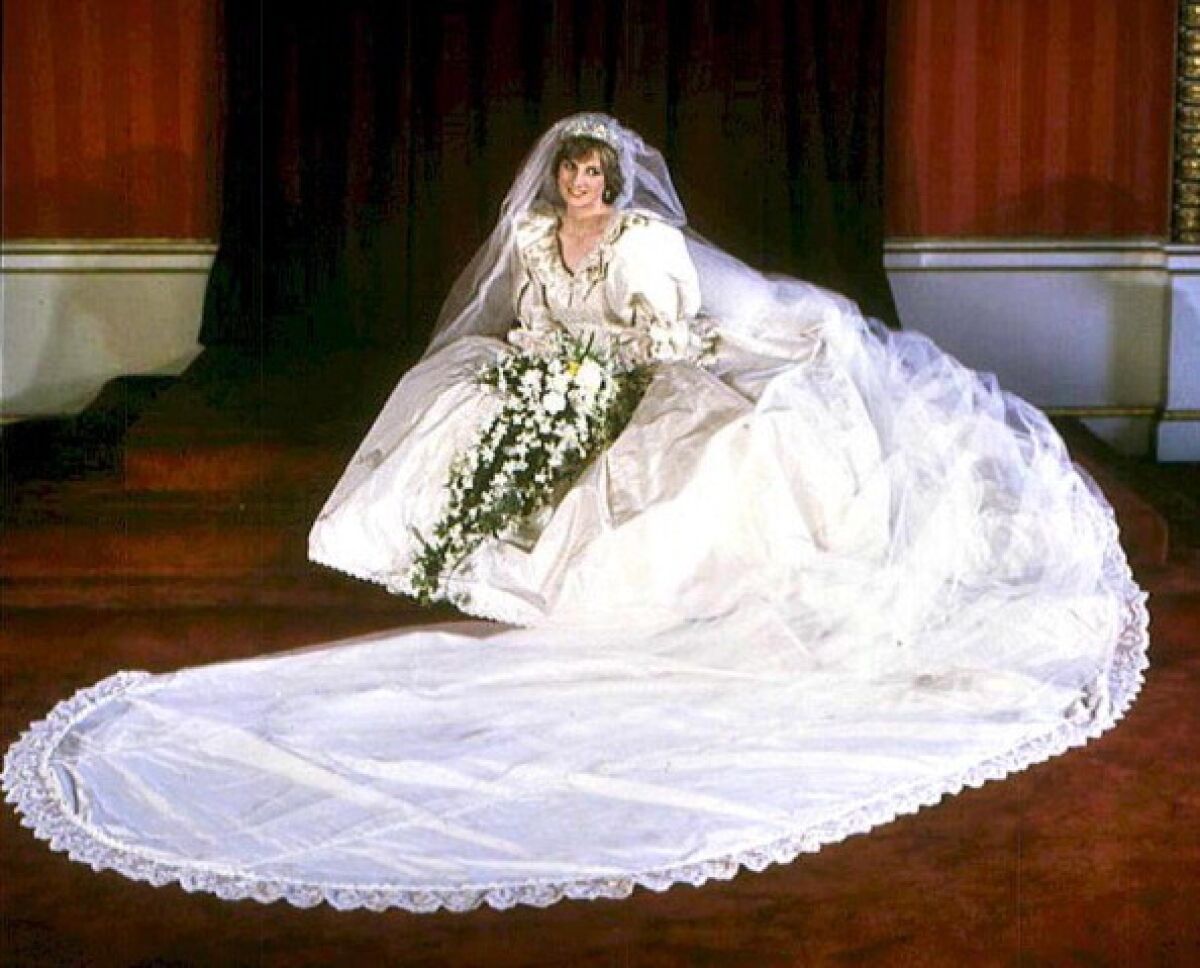 Diana, Princess of Wales sitting on the ground in her billowing wedding gown