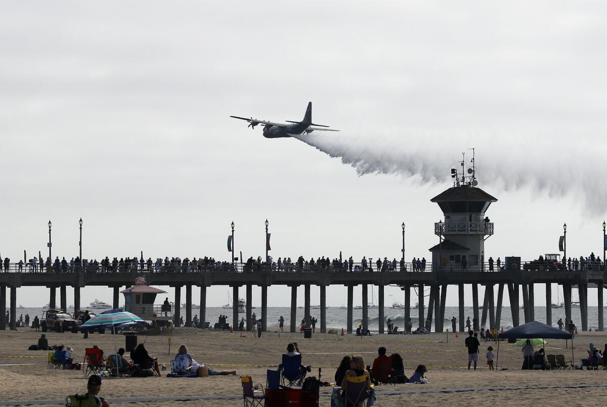 People stand along the Huntington Beach Pier at the Pacific Airshow on Sept. 30, 2022.