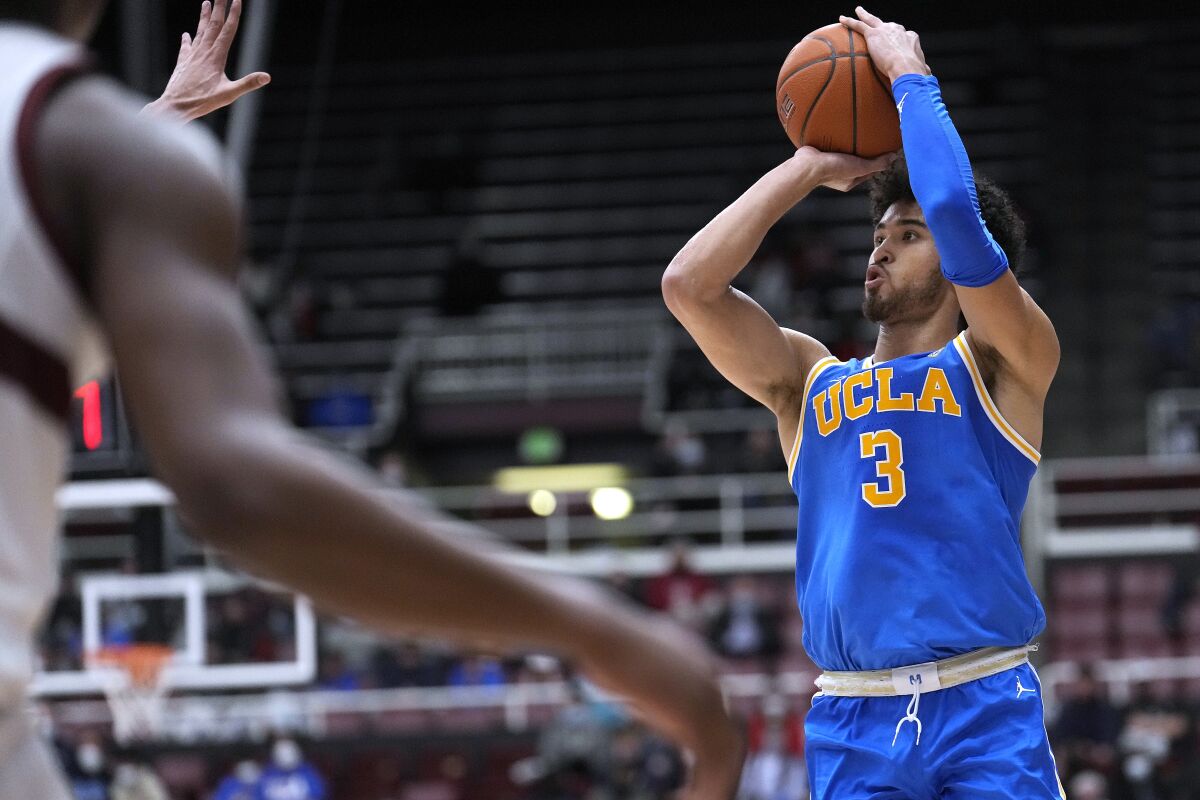 UCLA guard Johnny Juzang (3) takes a 3-point shot against Stanford during the second half of an NCAA college basketball game in Stanford, Calif., Tuesday, Feb. 8, 2022. (AP Photo/Tony Avelar)