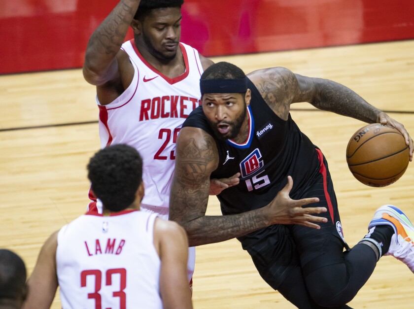 LA Clippers center DeMarcus Cousins (15) drives around Houston Rockets forward Cameron Oliver (25) during the first quarter of an NBA game Friday, May 14, 2021, in Houston. (Mark Mulligan/Houston Chronicle via AP)