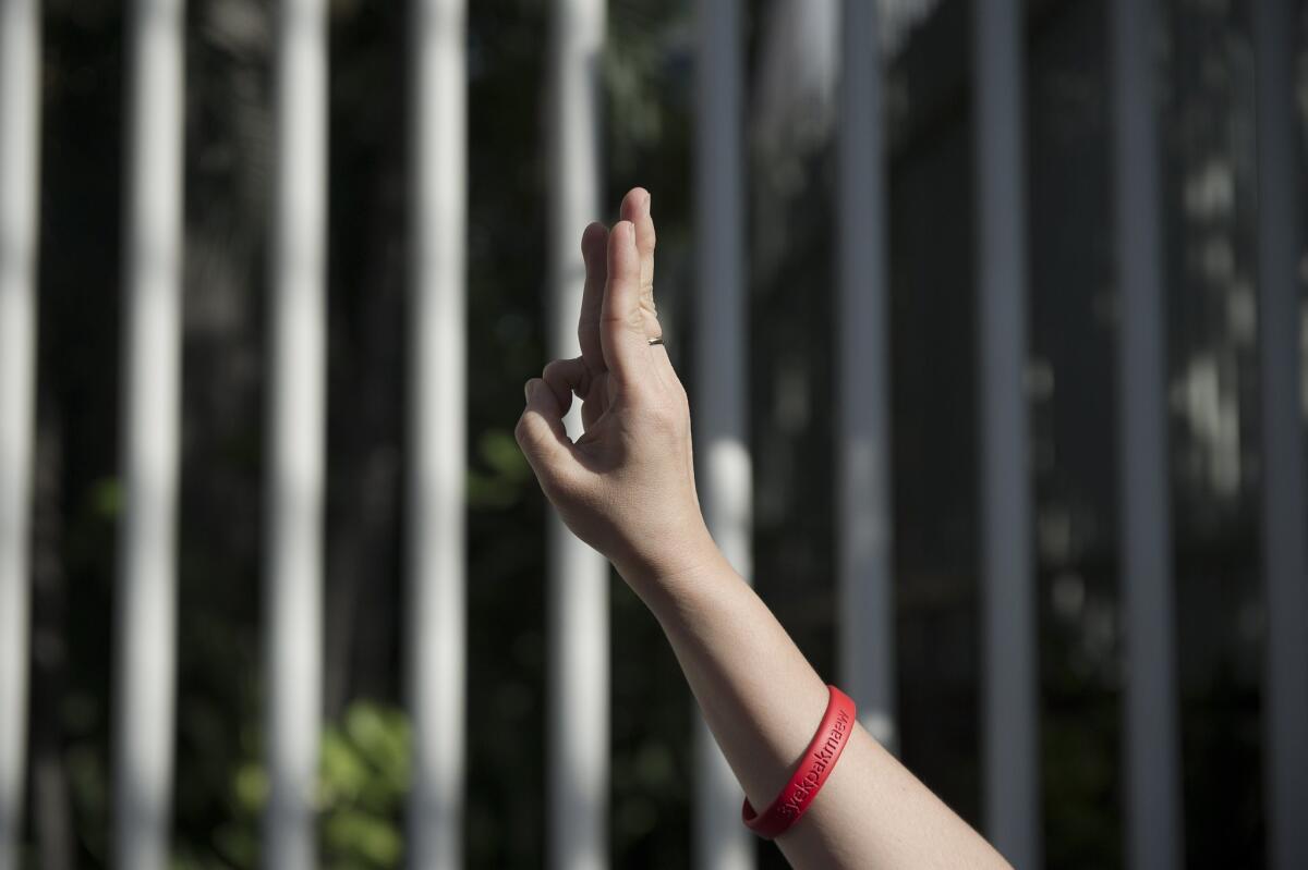 A Thai woman flashes the three-finger salute from "The Hunger Games" film series during a Bangkok rally in June against leaders of a military coup that has revoked democracy.