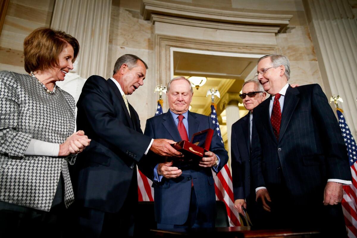 Retired professional golfer Jack Nicklaus, center, holds a Congressional Gold Medal on Capitol Hill in Washington. Flanking him from the left are House Minority Leader Nancy Pelosi (D-San Francisco), House Speaker John A. Boehner (R-Ohio), Senate Minority Leader Harry Reid (D-Nev.) and Senate Majority Leader Mitch McConnell (R-Ky.).