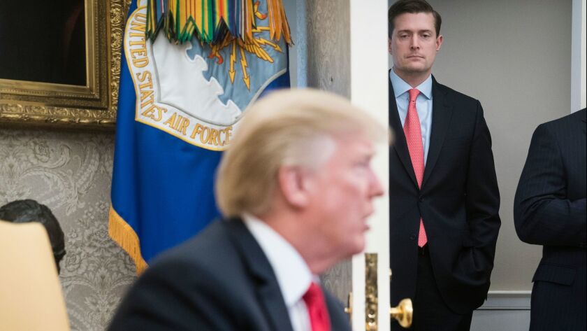 White House Staff Secretary Rob Porter watches as President Trump speaks during a meeting in the Oval Office on Feb. 2.