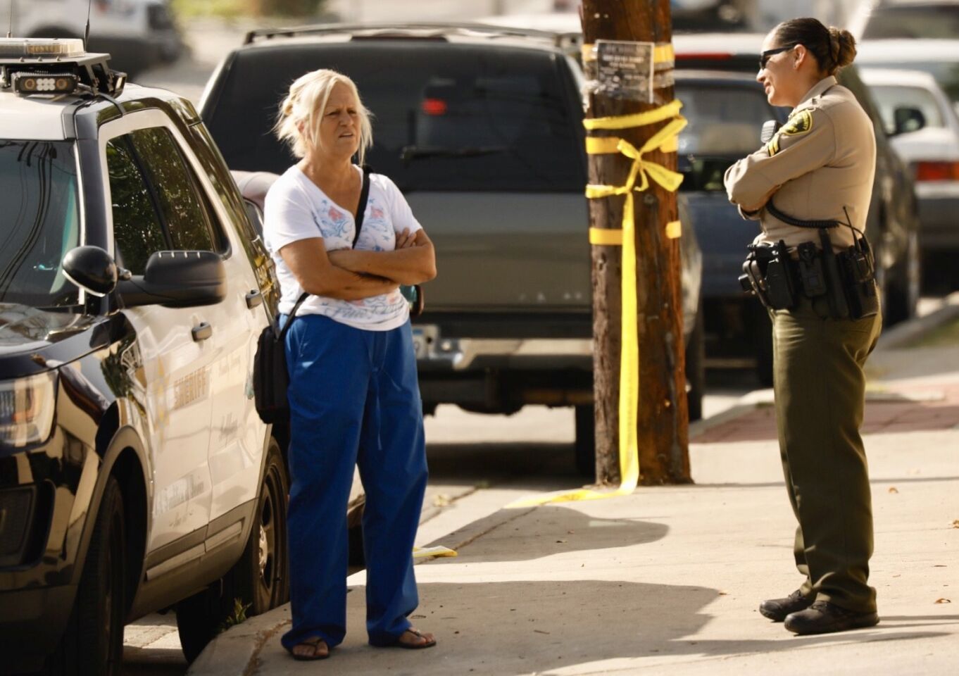 The mother of Rene Herrera, 39, speaks with a sheriff's official. Her son was killed after he opened fire on sheriff's deputies.