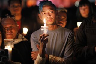 San Diego CA - November 21: People attend a candlelight vigil for the victims of the Club Q shooting at the Hillcrest Pride Flag in Hillcrest on Monday, November 21, 2022. (K.C. Alfred / The San Diego Union-Tribune)