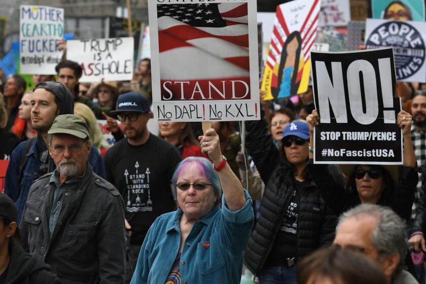Demonstrators march to the Federal Building in protest against U.S. President Donald Trump's executive order fast-tracking the Keystone XL and Dakota Access oil pipelines, in Los Angeles, California on February 5, 2017.