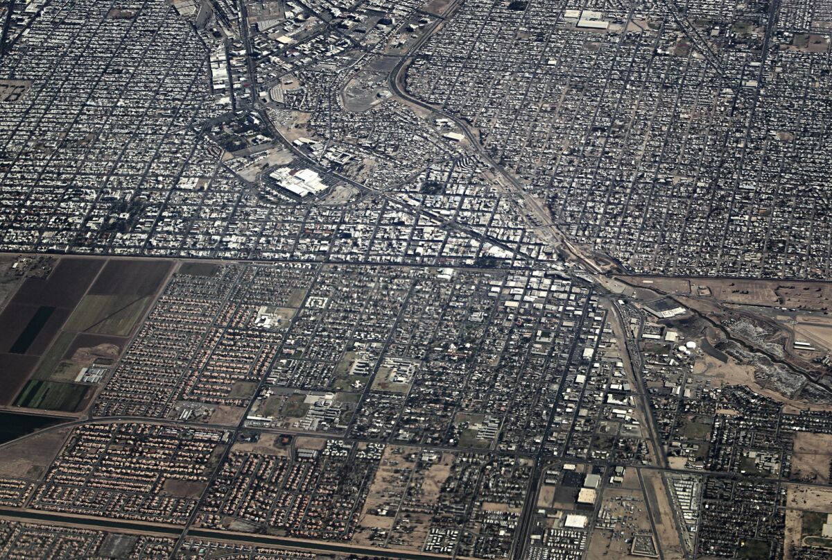 MARCH 21, 2012. MEXICALI, MEXICO & CALEXICO, CA. The U.S./Mexico border bisects this aerial view with the cities of Mexicali, Mexico at the top and Calexico, California at the bottom. In enforcement parlance, such communities are called melt zones, places where homes and shops on the U.S. side lie but a quick sprint away from Mexico. (Don Bartletti / Los Angeles Times)