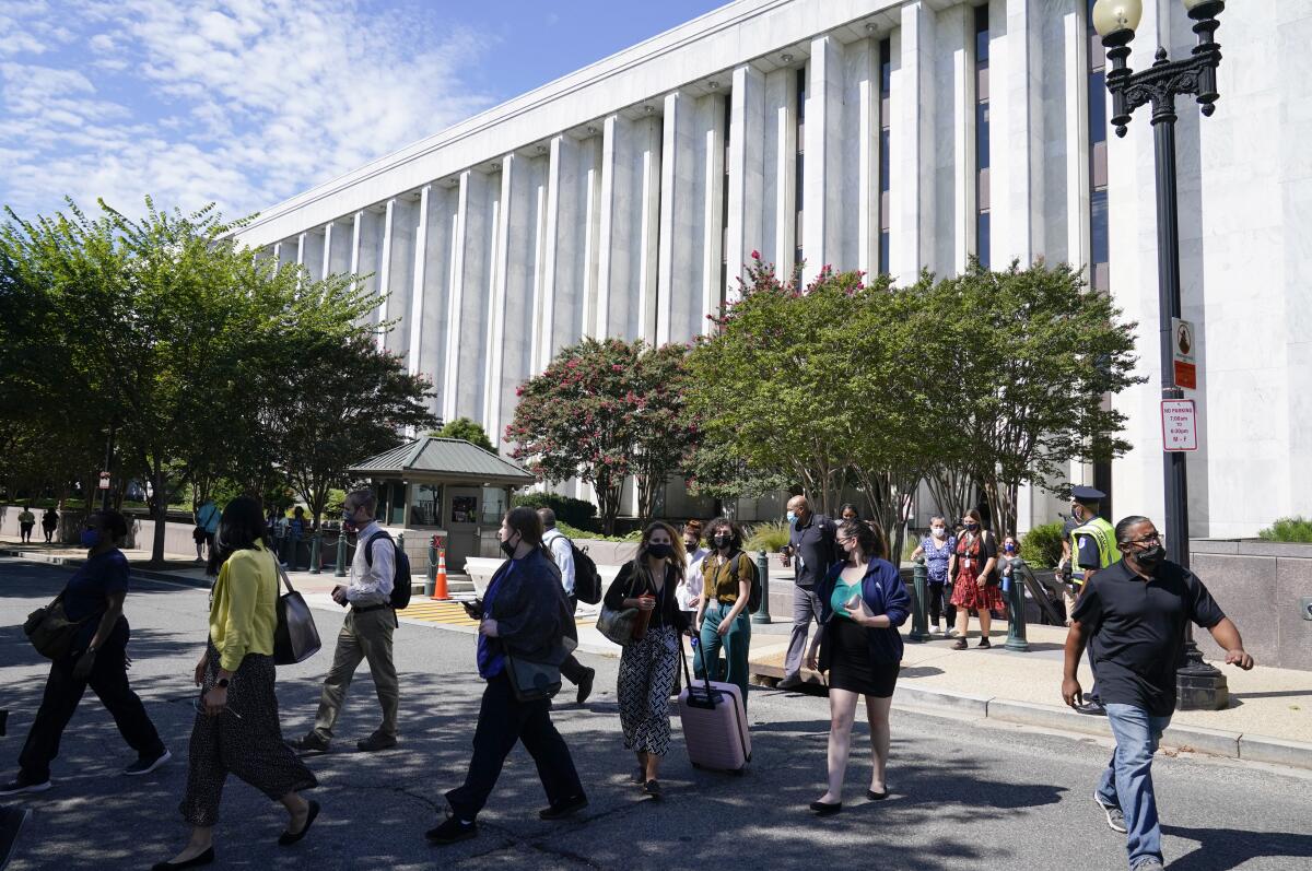 People are evacuated from the James Madison Memorial Building, a Library of Congress building.