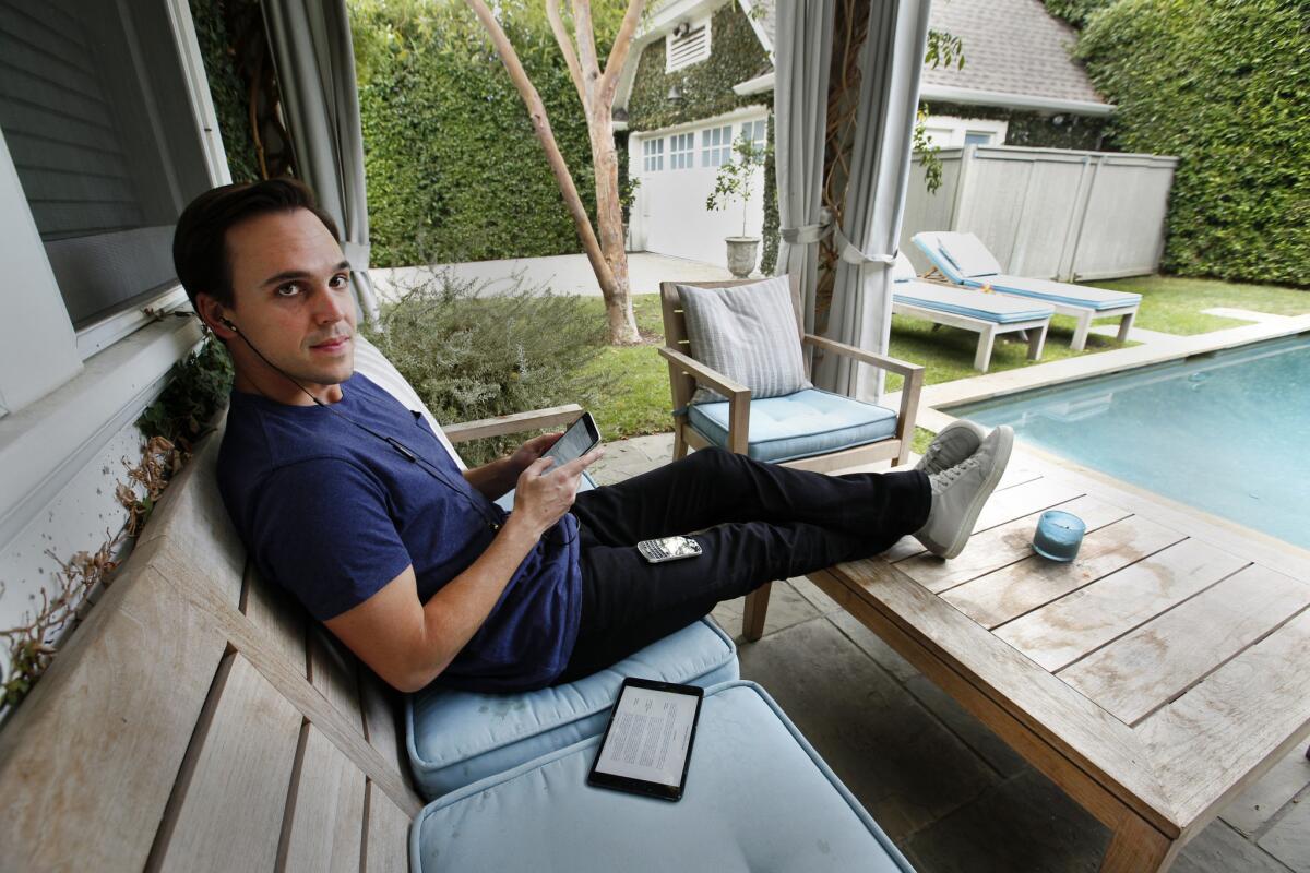Chris Hollod, pictured working by his backyard pool, is billionaire investor Ron Burkle's right-hand man when it comes to venture capital investments.