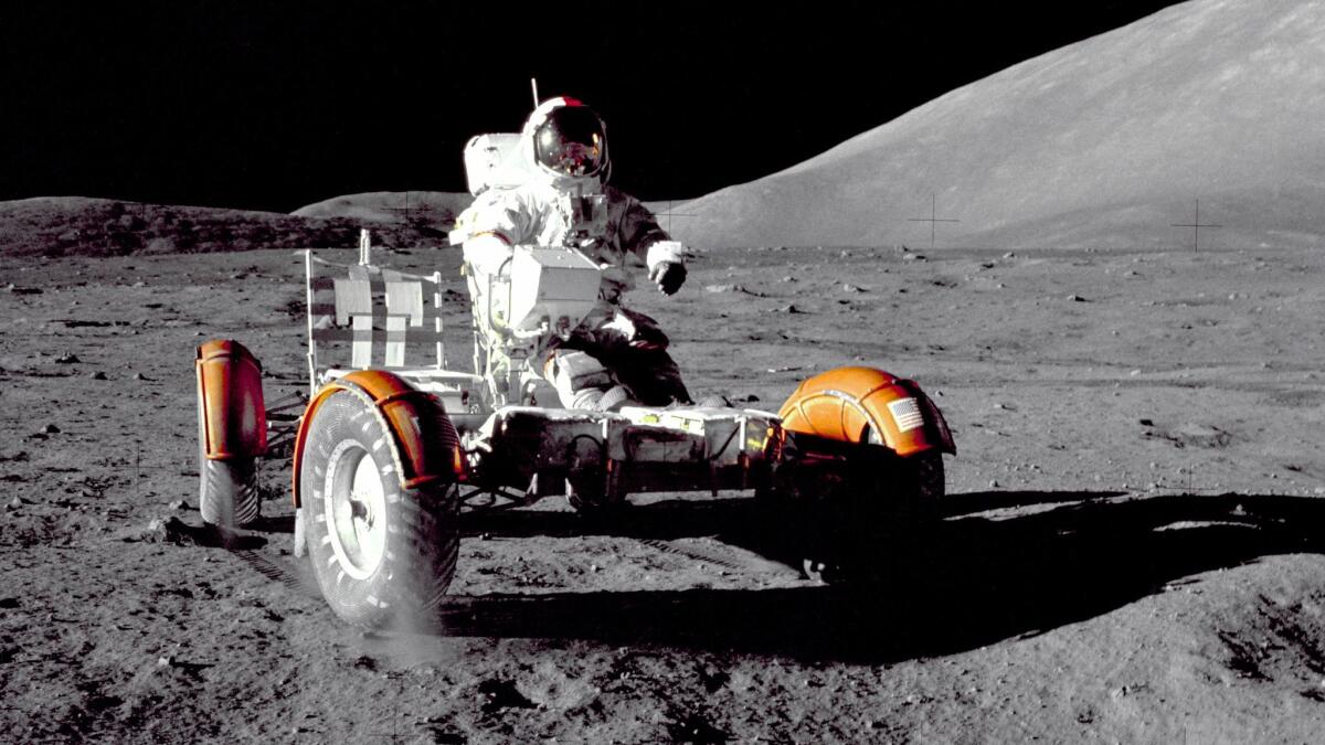 Astronaut Eugene A. Cernan, Apollo 17 mission commander, makes a short checkout of the Lunar Roving Vehicle during the early part of the first Apollo 17 extravehicular activity at the Taurus-Littrow landing site on Dec. 11, 1972. This view of the "stripped down" Rover is prior to loadup. This photograph was taken by Geologist-Astronaut Harrison H. Schmitt, Lunar Module pilot. The mountain in the right background is the East end of South Massif.