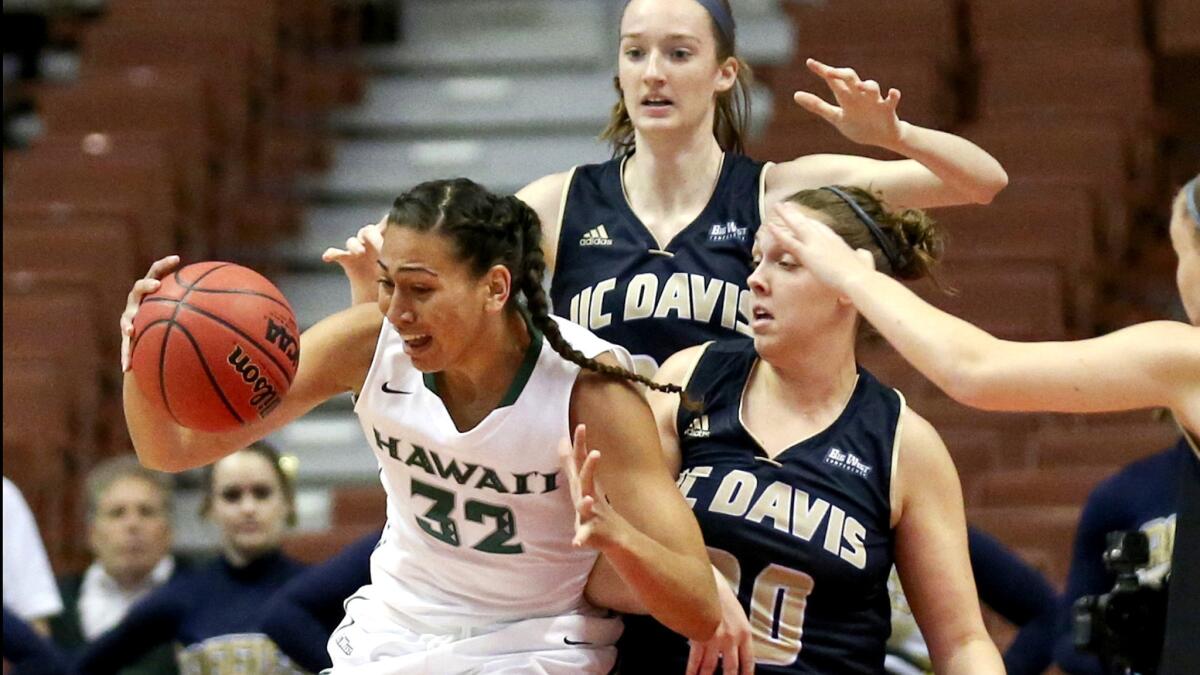 Hawaii center Kalei Adolpho tries to gather a pass in the lane against UC Davis forward Celia Marfone during the first half Saturday.