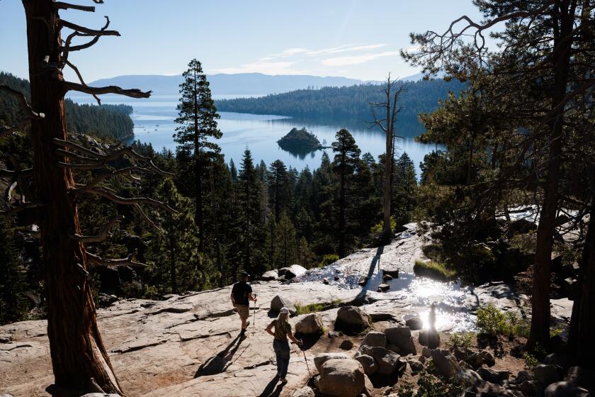 LAKE TAHOE CA AUGUST 9, 2023 - Jim and Leigh Gaston hike near Eagle Falls on Lake Tahoe near South Laket Tahoe, California on August 9, 2023. (Max Whittaker / For The Times)