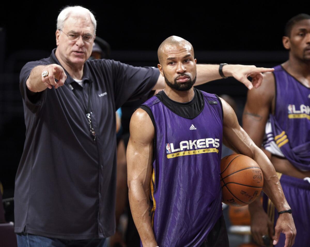 Former Lakers Coach Phil Jackson and Derek Fisher, pictured in 2010, will be reunited in New York after the former guard was named the Knicks' new head coach Monday.