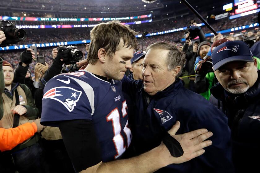 FILE - In this Jan. 21, 2018, file photo, New England Patriots quarterback Tom Brady, left, hugs coach Bill Belichick after the AFC championship NFL football game against the Jacksonville Jaguars in Foxborough, Mass. Opponents tend to freak out against Brady and Belichick just when they're about to conquer the New England Patriotsâ dynastic duo. The Philadelphia Eagles swear they wonât fall into that trap if they have the chance in Super Bowl 52. (AP Photo/David J. Phillip, File)