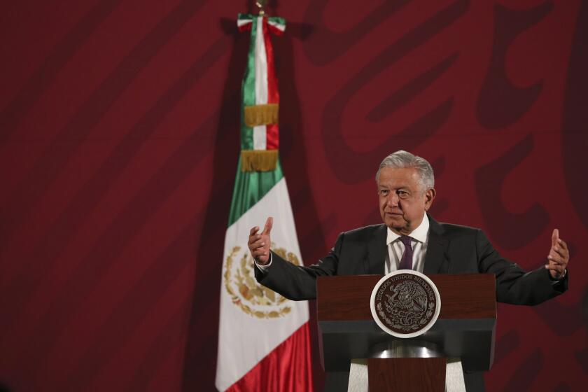 Mexico's President Andres Manuel Lopez Obrador gives his daily news conference at the presidential palace in Mexico City, early Thursday, March 19, 2020. (AP Photo/Fernando Llano)