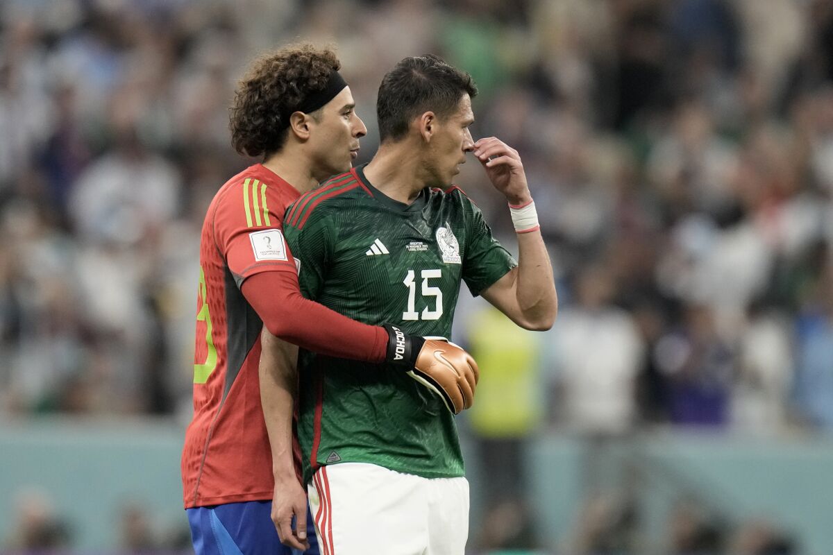 Mexico's goalkeeper Guillermo Ochoa embraces teammate Hector Moreno, right, 