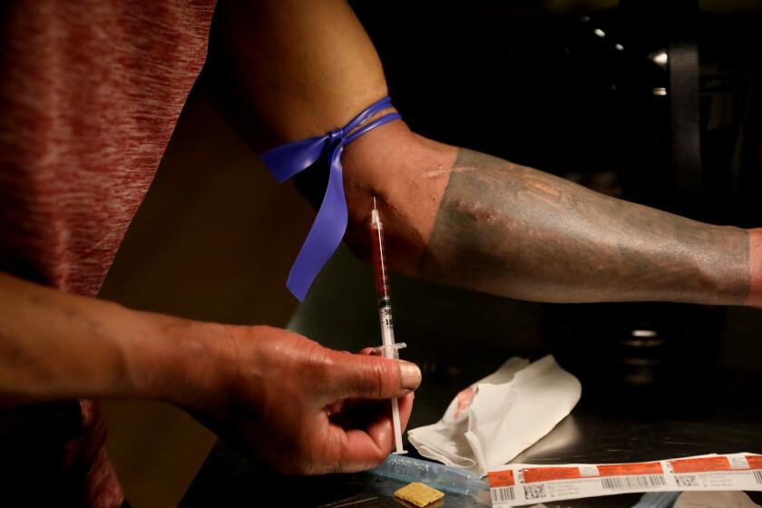 VANCOUVER, BRITISH COLUMBIA - MAY 04: Ramzy (cq) Diryas (cq), 29, of Port Moody, injects fentanyl while using an injection booth at a supervised consumption site where clients inject pre-obtained illicit drugs under the supervision of staff, located in the Downtown Eastside (DTES) neighborhood. Clean injection equipment such as syringes, cookers, filters, water and tourniquets are supplied, in the Downtown Eastside (DTES) neighborhood on Wednesday, May 4, 2022 in Vancouver, British Columbia. Supervised consumption sites in the DTES give addicts who use fentanyl, opioids, crystal methamphetamine and other drugs a place to use and get harm reduction supplies; clean syringes, alcohol swabs, sterile water, tourniquets, spoons and filters. On April 14, 2016, provincial health officer Dr. Perry Kendall declared a public health emergency under the Public Health Act due to the significant rise in opioid-related overdose deaths reported in B.C. since the beginning of 2016. (Gary Coronado / Los Angeles Times)