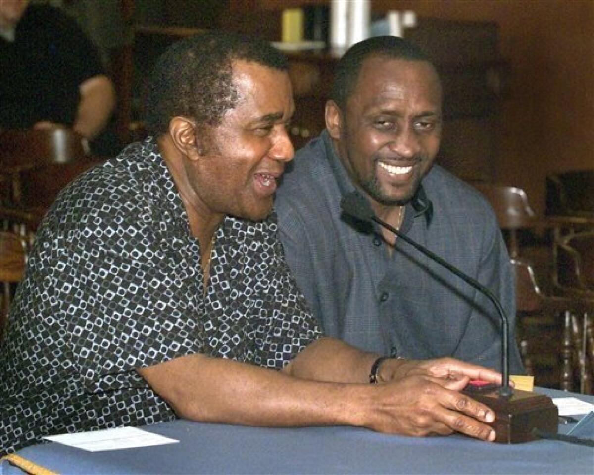 FILE-This May 26, 2004 file photo shows president of the Kronk Gym Emanuel Steward, left, sharing a laugh with Tommy "Hitman" Hearns during testimony on legislation to reform the boxing industry at the Michigan State Capitol in Lansing, Mich. Steward, the owner of the legendary Kronk Gym and one of boxing's greatest trainers, has died. He was 68. Victoria Kirton, Steward's executive assistant, says Steward died Thursday Oct. 25, 2012 in a Chicago hospital. She did not disclose the cause of death. (AP Photo/Daymon J. Hartley, File)